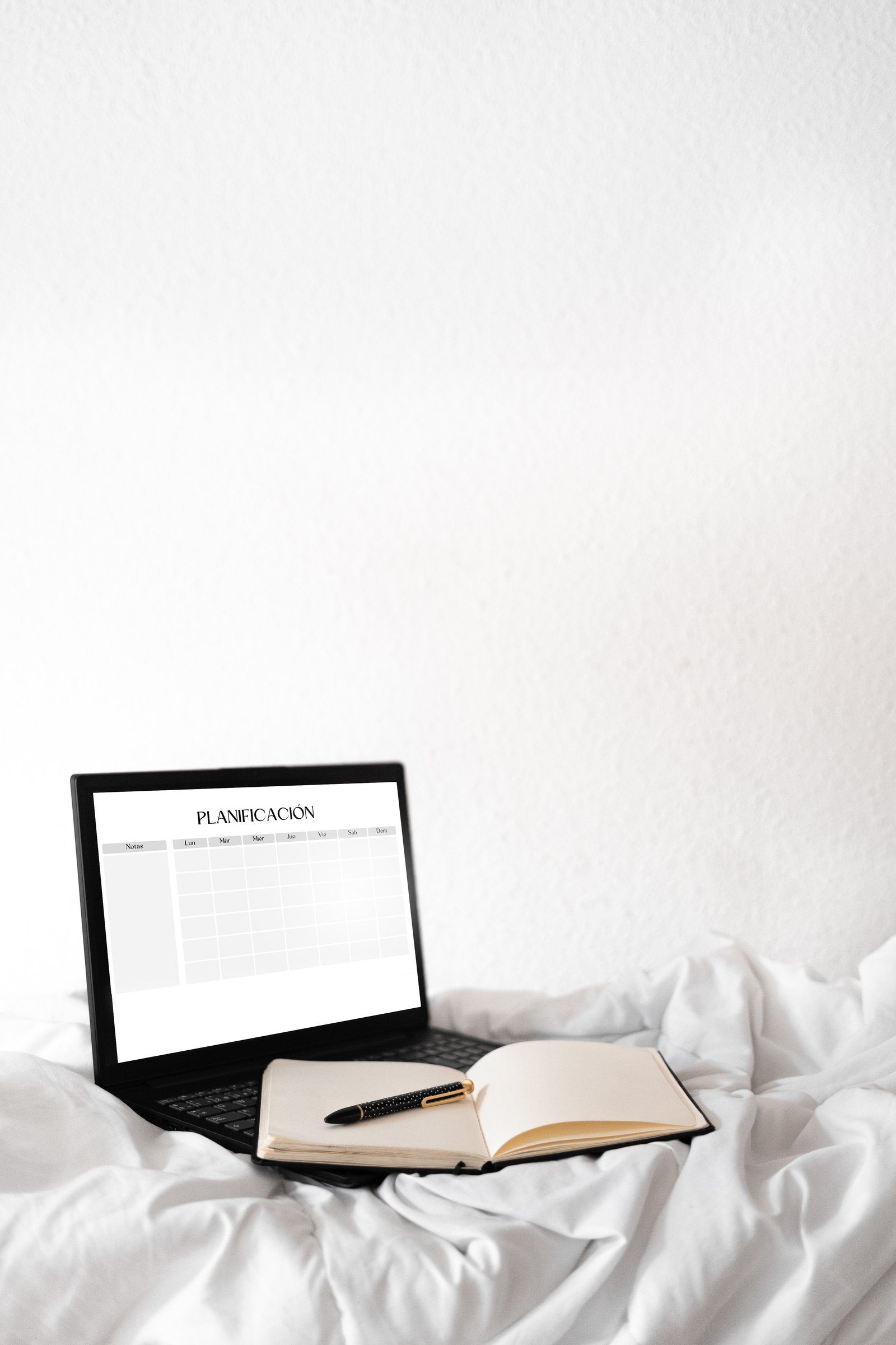 Laptop and Book on Bed