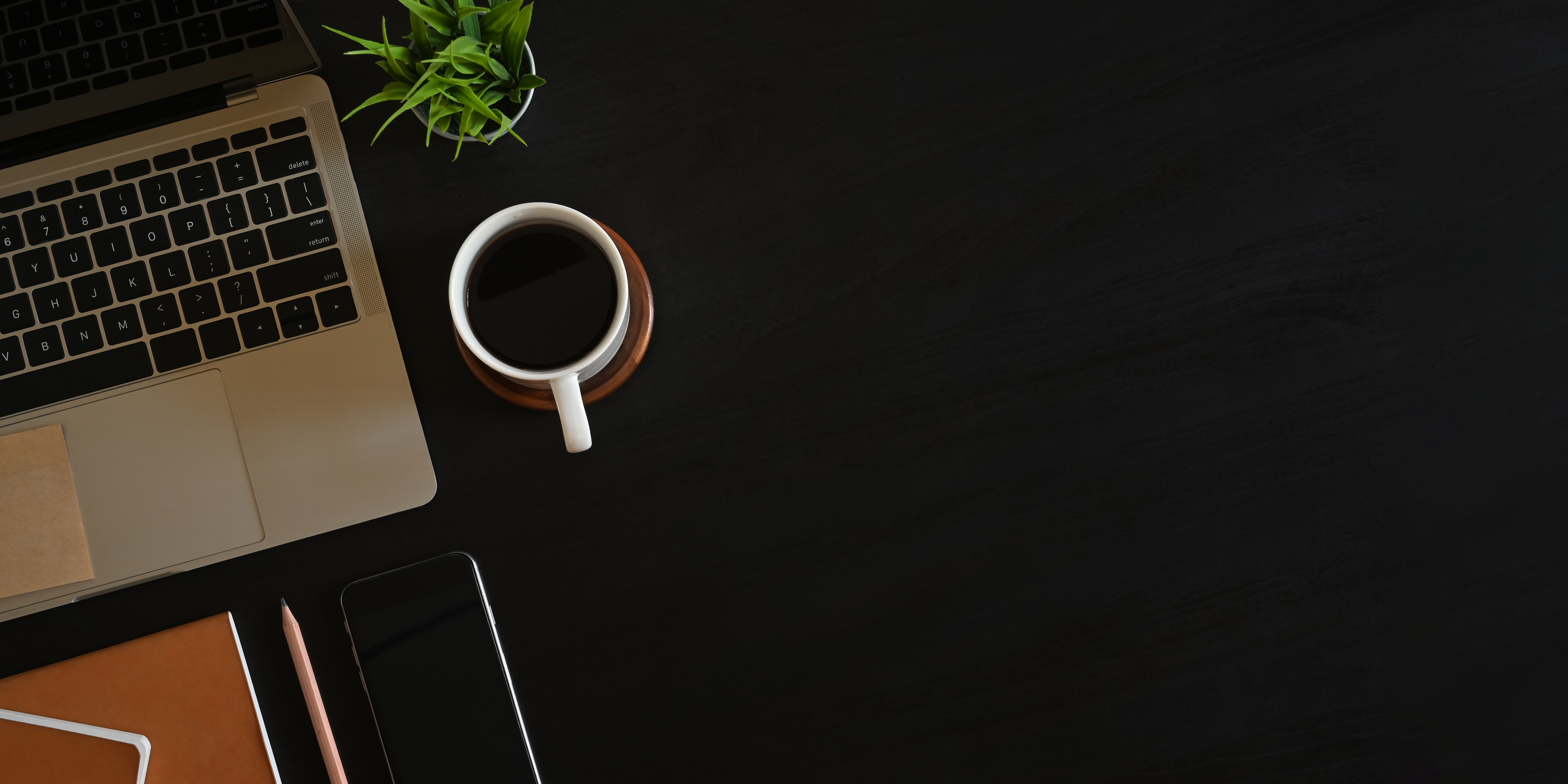 Flatlay of a Black Office Desk With a Laptop